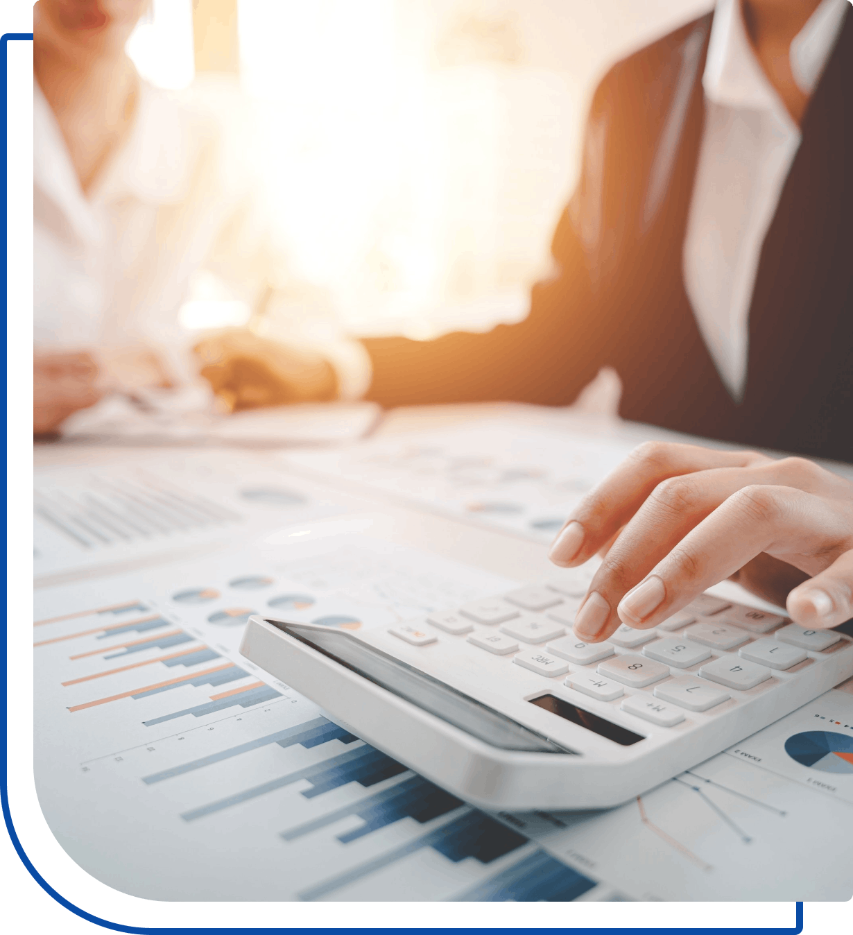 Person using calculator on financial documents.